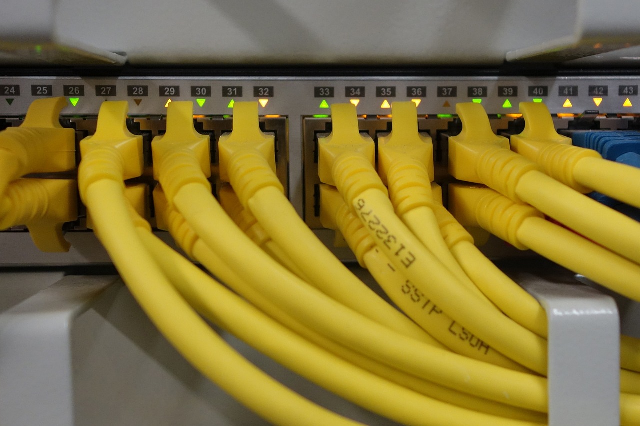 A bunch of yellow wires are connected to the back of a wall.